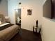 Bedroom featuring an illuminated flat screen tv, dark carpet and connecting bathroom at 21103 Patio View Ct # 3302, Lutz, FL 33558