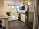 Well-equipped kitchen featuring white cabinets, stainless steel appliances, and black countertop accents at 21103 Patio View Ct # 3302, Lutz, FL 33558