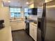 Bright kitchen featuring stainless steel appliances, white cabinetry, and ample counter space at 21103 Patio View Ct # 3302, Lutz, FL 33558