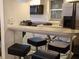 Kitchen bar with black barstools and stainless steel appliances at 21103 Patio View Ct # 3302, Lutz, FL 33558