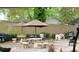 Charming outdoor patio area with stone pavers, umbrellas, and an array of seating options at 21103 Patio View Ct # 3302, Lutz, FL 33558