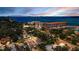 Scenic aerial view of the community showcasing waterfront buildings, lush greenery, and a glimpse of the expansive ocean at 214 Scotland St, Dunedin, FL 34698