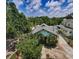 Aerial view of a charming home surrounded by lush greenery and blue sky at 214 Scotland St, Dunedin, FL 34698