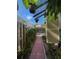 Cozy backyard with a brick walkway, patio furniture, and a pergola at 214 Scotland St, Dunedin, FL 34698