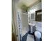 Bathroom features a tiled floor, toilet, sink, and shower at 214 Scotland St, Dunedin, FL 34698