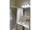 Bathroom with shower-tub combo, vanity sink, and floral shower curtain at 214 Scotland St, Dunedin, FL 34698