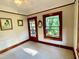 Bright bedroom has wooden trim, neutral walls, and large windows, creating a warm, inviting atmosphere at 214 Scotland St, Dunedin, FL 34698