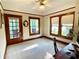 Bright bedroom with hardwood trim, ceiling fan, and windows providing plenty of natural light at 214 Scotland St, Dunedin, FL 34698