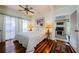 Comfortable bedroom with hardwood floors, ample natural light, and a ceiling fan at 214 Scotland St, Dunedin, FL 34698