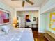 Cozy bedroom with hardwood floors, a ceiling fan, and an open closet at 214 Scotland St, Dunedin, FL 34698