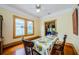 Bright dining room with hardwood floors and a beautifully set table at 214 Scotland St, Dunedin, FL 34698