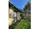 Exterior view features shutters, colorful flowers, and lots of greenery at 214 Scotland St, Dunedin, FL 34698