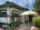 Charming home with patio featuring dining set and shade at 214 Scotland St, Dunedin, FL 34698