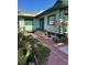 Cozy home with garden space and exterior steps at 214 Scotland St, Dunedin, FL 34698