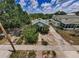 Aerial view of charming home with mature trees and spacious yard at 214 Scotland St, Dunedin, FL 34698