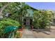 Charming bungalow with lush landscaping and a welcoming front porch and mailbox at 214 Scotland St, Dunedin, FL 34698
