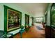 Inviting front porch featuring cozy seating and view to the exterior of the home at 214 Scotland St, Dunedin, FL 34698