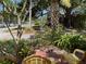 Beautifully landscaped front yard with tropical plants and outdoor seating at 214 Scotland St, Dunedin, FL 34698