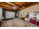 Spacious garage with concrete floor, wood beams and an automatic door, offering ample storage space at 214 Scotland St, Dunedin, FL 34698