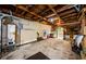 Unfinished garage with visible wood rafters, concrete flooring, and storage shelves providing ample space at 214 Scotland St, Dunedin, FL 34698
