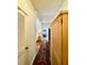 Hallway provides access to bedroom with hardwood floors and an adjacent armoire at 214 Scotland St, Dunedin, FL 34698
