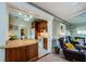Open kitchen layout with island, wood cabinets, and an adjacent living area at 214 Scotland St, Dunedin, FL 34698