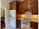 Kitchen with stainless steel appliances, light backsplash, and wood cabinets at 214 Scotland St, Dunedin, FL 34698