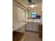 Laundry room with washer, dryer, and ironing board at 214 Scotland St, Dunedin, FL 34698