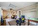 Open living room with a cozy sitting area, functional workspace, and views into the kitchen at 214 Scotland St, Dunedin, FL 34698