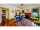 Bright living room with hardwood floors, a fireplace, and stylish vintage furnishings at 214 Scotland St, Dunedin, FL 34698