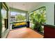 Relaxing porch swing with colorful pillows offering a serene outdoor space at 214 Scotland St, Dunedin, FL 34698