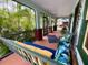 Inviting porch with a comfortable swing and stylish pillows at 214 Scotland St, Dunedin, FL 34698