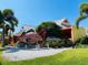 Unique restaurant exterior featuring colorful signage, a large fish statue, and lush landscaping at 214 Scotland St, Dunedin, FL 34698