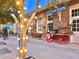 Charming brick train depot with vintage cart and decorative string lights at 214 Scotland St, Dunedin, FL 34698