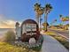 Welcome to Dunedin sign with palm trees, sculpture, and street view enhancing the property's appeal and location at 214 Scotland St, Dunedin, FL 34698