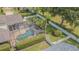 Aerial view of a backyard oasis featuring a screened-in pool and fenced yard at 2146 Gold Dust Ct, Trinity, FL 34655