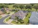Well-manicured lawn and mature landscaping surround this home with a screened-in lanai at 2146 Gold Dust Ct, Trinity, FL 34655