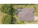 Aerial view of the kidney-shaped pool inside of a screened enclosure, in a backyard with a white fence at 2146 Gold Dust Ct, Trinity, FL 34655