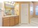 Bright bathroom featuring a soaking tub, vanity with granite countertop, and large mirror at 2146 Gold Dust Ct, Trinity, FL 34655