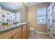Bathroom vanity featuring a granite countertop and shower with curtain at 2146 Gold Dust Ct, Trinity, FL 34655