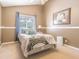 Comfortable bedroom featuring a large window and neutral decor at 2146 Gold Dust Ct, Trinity, FL 34655