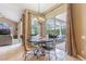 Cozy dining area with a round table, decorative chandelier, and sliding glass doors leading to the screened pool at 2146 Gold Dust Ct, Trinity, FL 34655