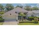 Attractive single-story home featuring a manicured lawn, a two-car garage, and mature landscaping at 2146 Gold Dust Ct, Trinity, FL 34655