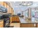 Bright kitchen featuring granite countertops, stainless steel appliances, and a view of the dining area at 2146 Gold Dust Ct, Trinity, FL 34655