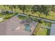 Backyard aerial view features a screened-in pool and well-manicured landscaping at 2146 Gold Dust Ct, Trinity, FL 34655