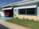 Charming home exterior with stone accents, well-maintained lawn, and a convenient carport with a red car at 250 Rosery Nw Rd # 270, Largo, FL 33770