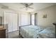 Bright bedroom featuring a ceiling fan, double closets, and a comfortable bed, creating a relaxing space at 2507 Dewberry St, Valrico, FL 33596