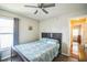 Comfortable bedroom with a ceiling fan, wooden-framed bed, and hardwood floors, with a bright, airy feel at 2507 Dewberry St, Valrico, FL 33596