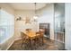 Cozy dining room featuring a wooden table set, decorative shelving, and natural light from a window at 2507 Dewberry St, Valrico, FL 33596