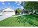 Charming home featuring a lush lawn, a screened-in porch, and an attached two-car garage at 2507 Dewberry St, Valrico, FL 33596